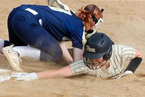 Penn's Addisyn Baird, right, slides safely into first during a high school softball game between New Prairie and Penn at New