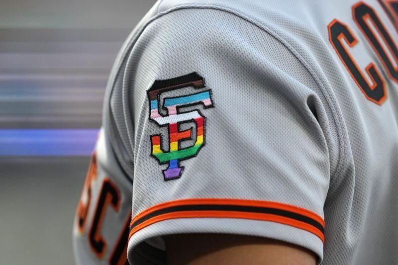 Jun 16, 2023; Los Angeles, California, USA; A rainbow colored San Francisco Giants logo on the sleeve of left fielder Michael Conforto (8) during LGBTQ+ Pride Night at Dodger Stadium at Dodger Stadium. Mandatory Credit: Kirby Lee-USA TODAY Sports