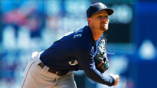 San Diego Padres first baseman Matt Carpenter, right, makes a catch at  first base to get Seattle Mariners' Teoscar Hernandez, left, out during the  second inning of a spring training baseball game