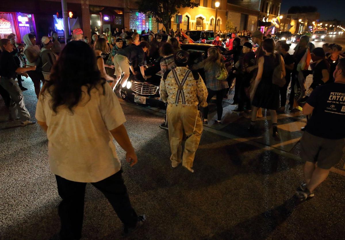 Car drives through protesters in St. Louis