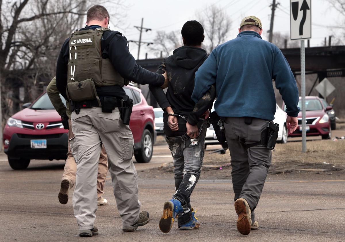Photos: Police car chase ends with crash, one shot, two arrested