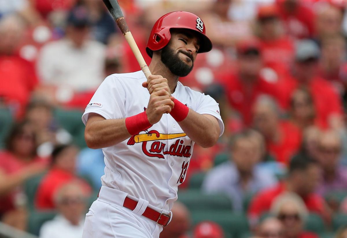 St. Louis Cardinals' Matt Carpenter wears camouflage socks as part of his  Memorial Day uniform as he fouls a ball off his leg while batting during  the first inning of a baseball