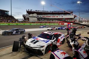 May 18, 2025; North Wilkesboro, North Carolina, USA; NASCAR Cup Series driver Christopher Bell (20) makes a pit stop during NASCAR All-Star Open at North Wilkesboro Speedway. Mandatory Credit: Peter Casey-Imagn Images