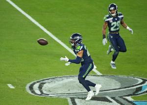 Feb 8, 2026; Santa Clara, CA, USA; Seattle Seahawks safety Julian Love (20) intercepts a pass against the New England Patriots in the second half in Super Bowl LX at Levi's Stadium. Mandatory Credit: Kirby Lee-Imagn Images