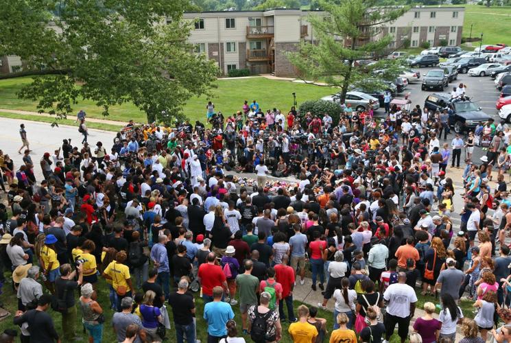 People gather on the anniversary of the fatal police shooting of Michael Brown