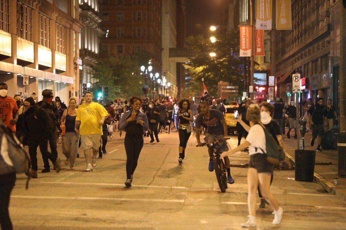 Protesters run downtown