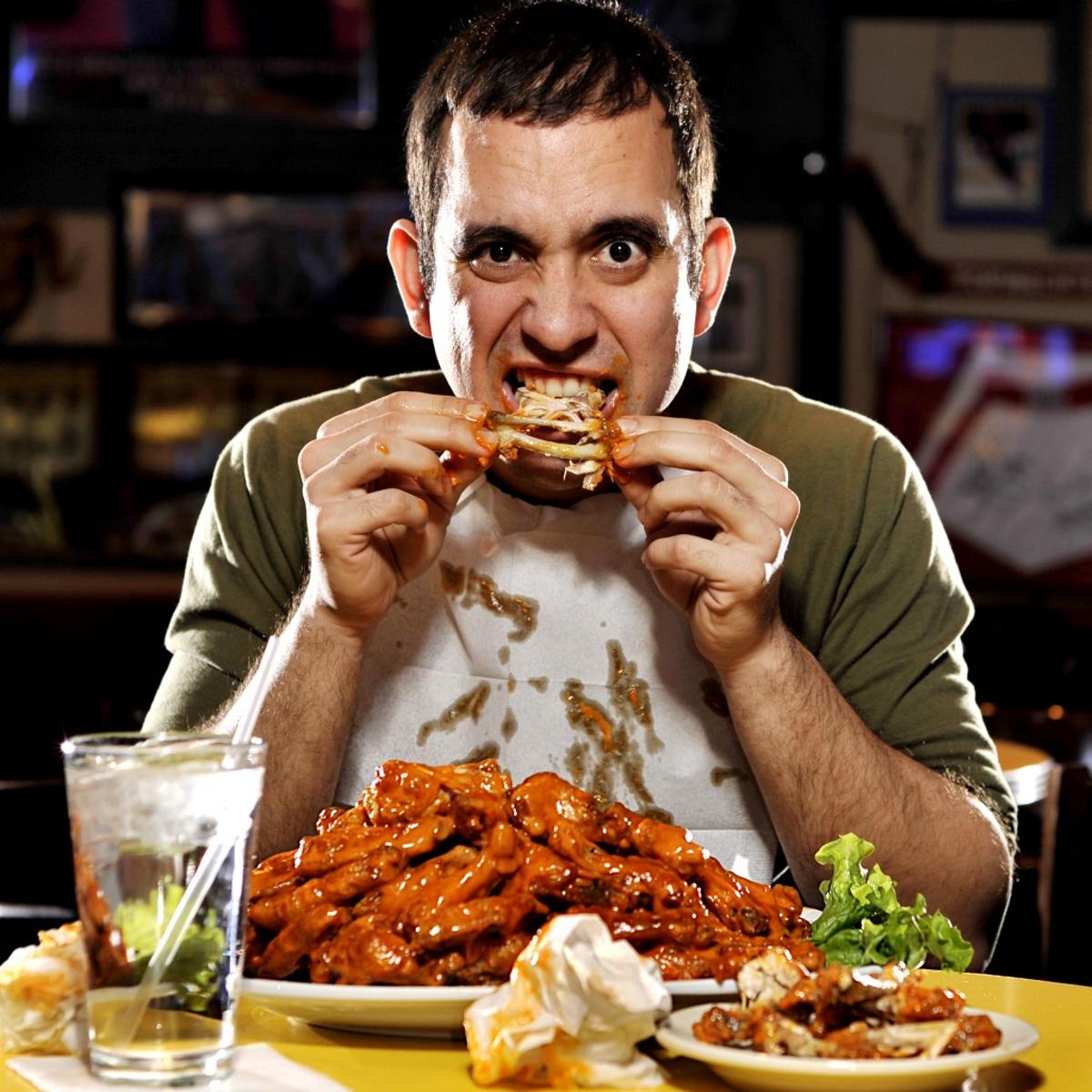 Man eating chicken wings