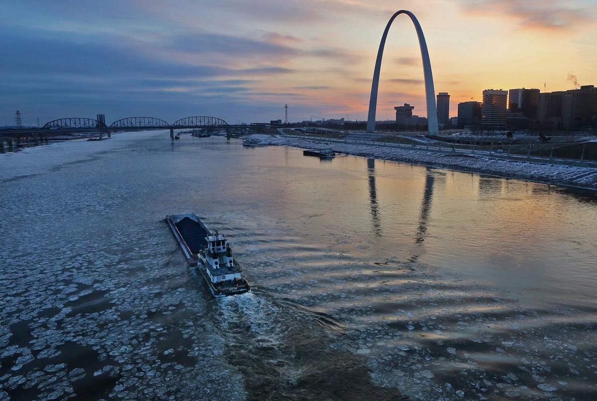 Barges navigate the icy Mississippi River