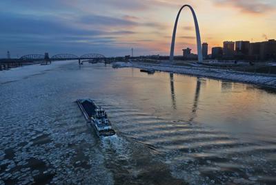 Barges navigate the icy Mississippi River