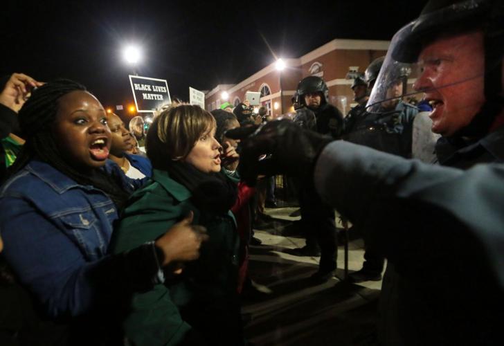 More than 150 demonstrators protest in front of Ferguson Police Station
