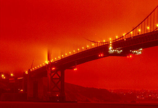 AP PHOTOS: Wildfires race through dry, windy California