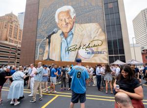 Fans attend a tailgate-themed celebration marking the completion of “Mr. Baseball,” a new 80-by-100-foot mural by artist Mauricio Ramirez depicting longtime Milwaukee Brewers broadcaster Bob Uecker in Milwaukee, Wisconsin on June 30, 2026.