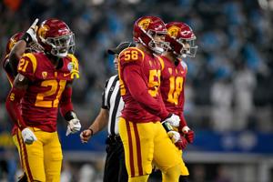 USC Trojans defensive back Latrell McCutchin (21) and defensive end Solomon Tuliaupupu (58) celebrate during the game between the USC Trojans and the Tulane Green Wave in the 2023 Cotton Bowl at AT&T Stadium.