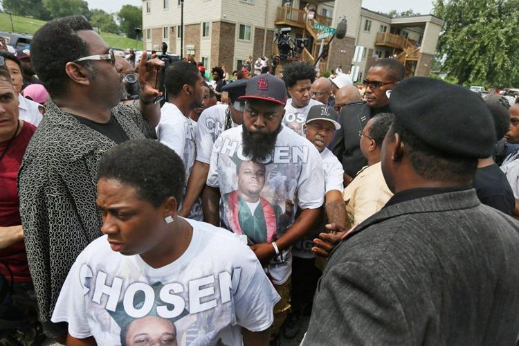 People gather on the anniversary of the fatal police shooting of Michael Brown
