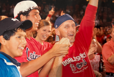 Jacob Buffa celebrates catching Albert Pujols foul ball with his brother and father
