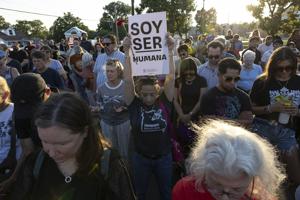 Community holds vigil for Overland couple slain after deportation