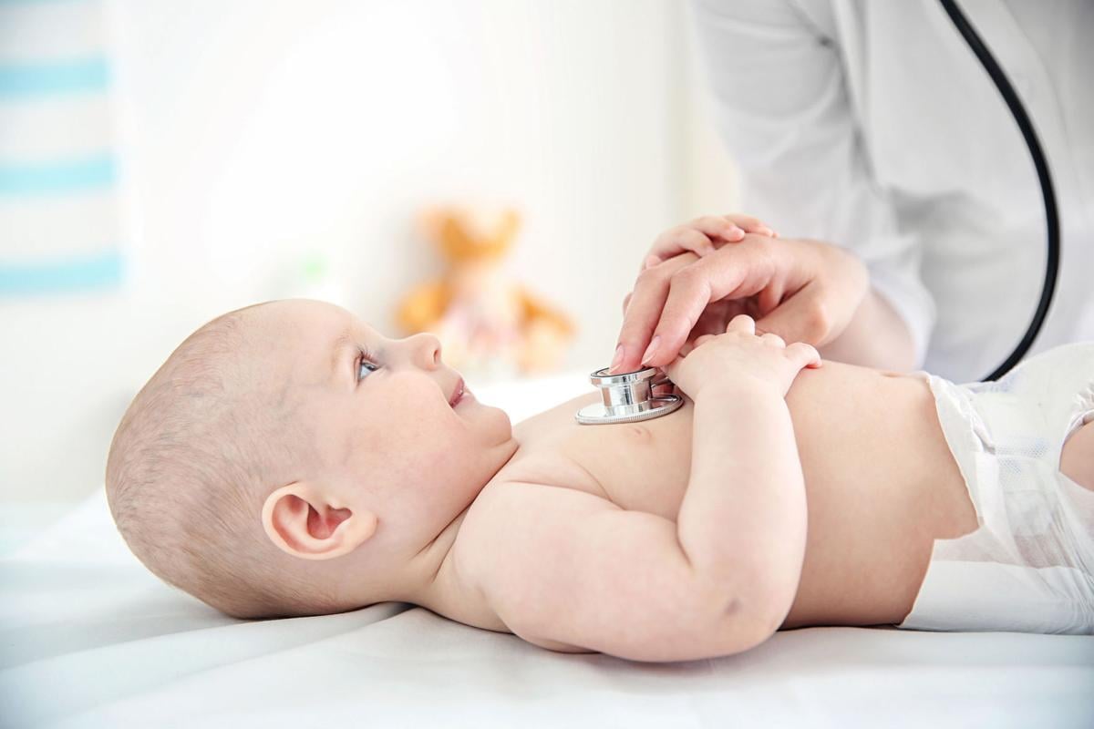 Pediatrician examining infant