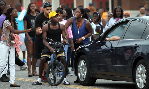 Scores protest police shooting of Michael Brown