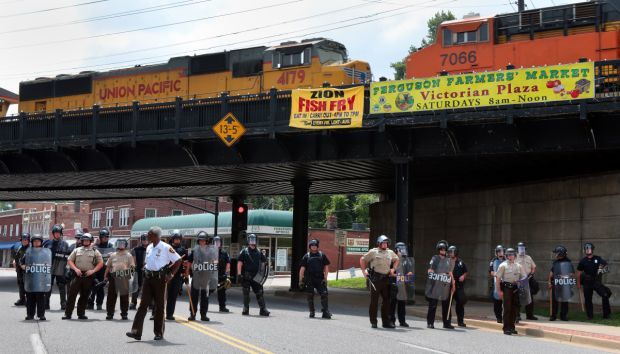Riot officers staff a roadblock in Ferguson