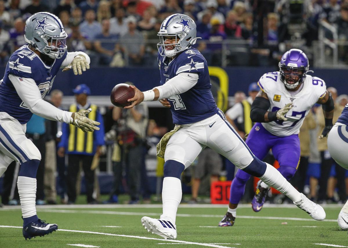 Dallas Cowboys quarterback Dak Prescott (4) hands off to running back Ezekiel Elliott (21) during the first quarter on Sunday, Nov. 10, 2019 at AT&T Stadium in Arlington, Texas.