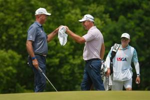 Stewart Cink gives Padraig a fist bump on the 14th green during the third round of the U.S. Senior Open at Scioto Country Club