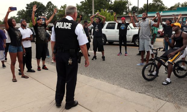 Scores protest police shooting of Michael Brown