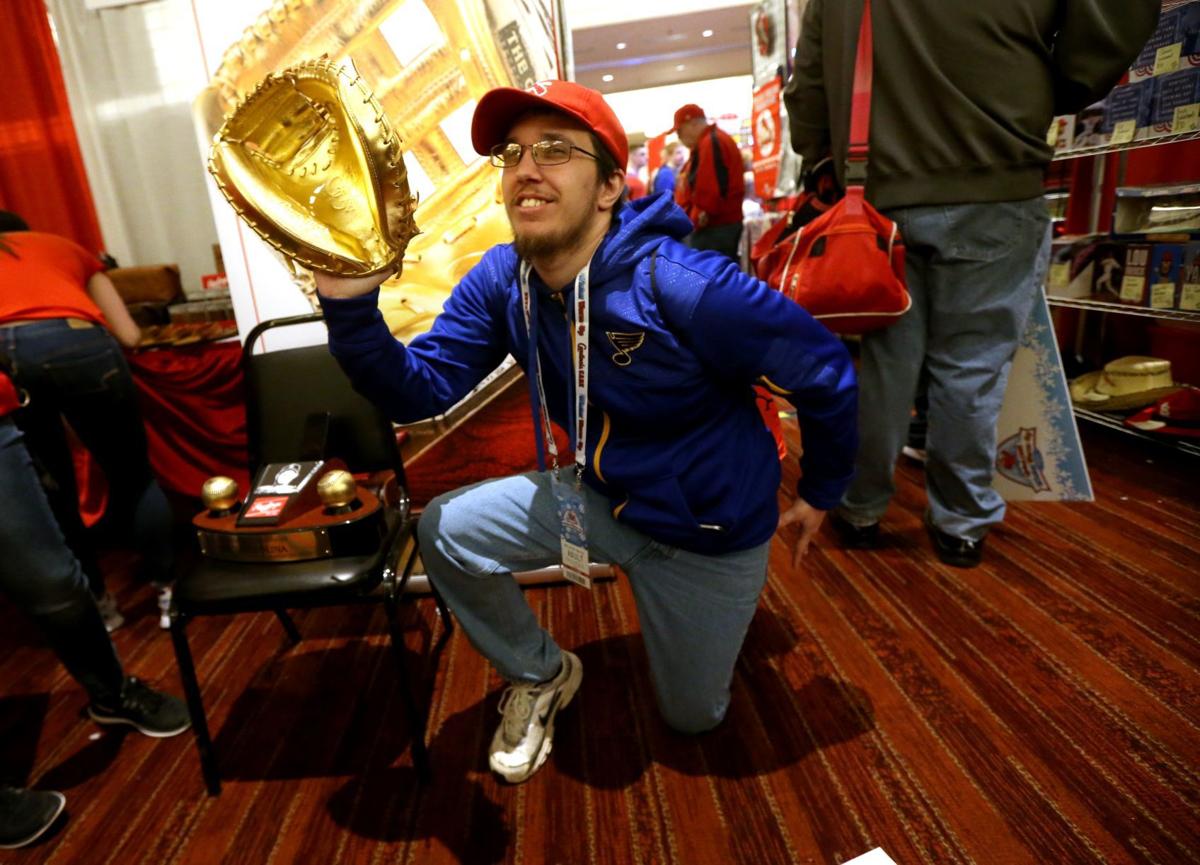 St. Louis Cardinals slugger Albert Pujols stops his autograph session to  sign for son A.J. (5) during the Cardinals Winter Warm-Up in St. Louis on  January 13, 2007. Over 25 thousand badges