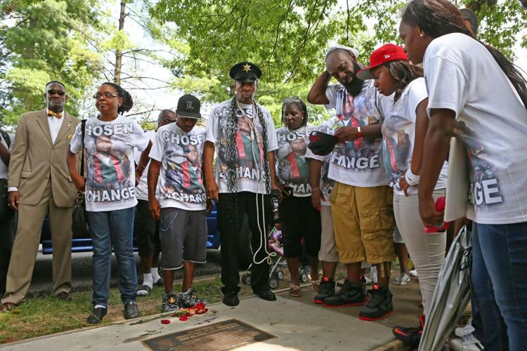 People gather on the anniversary of the fatal police shooting of Michael Brown