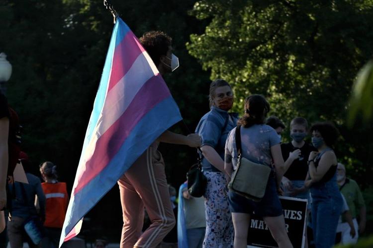 Protester carries the transgender flag