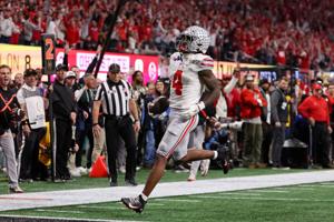 Ohio State wide receiver Jeremiah Smith (4) runs for a touchdown against Notre Dame during the first half of the College Football Playoff championship game at Mercedes-Benz Stadium.