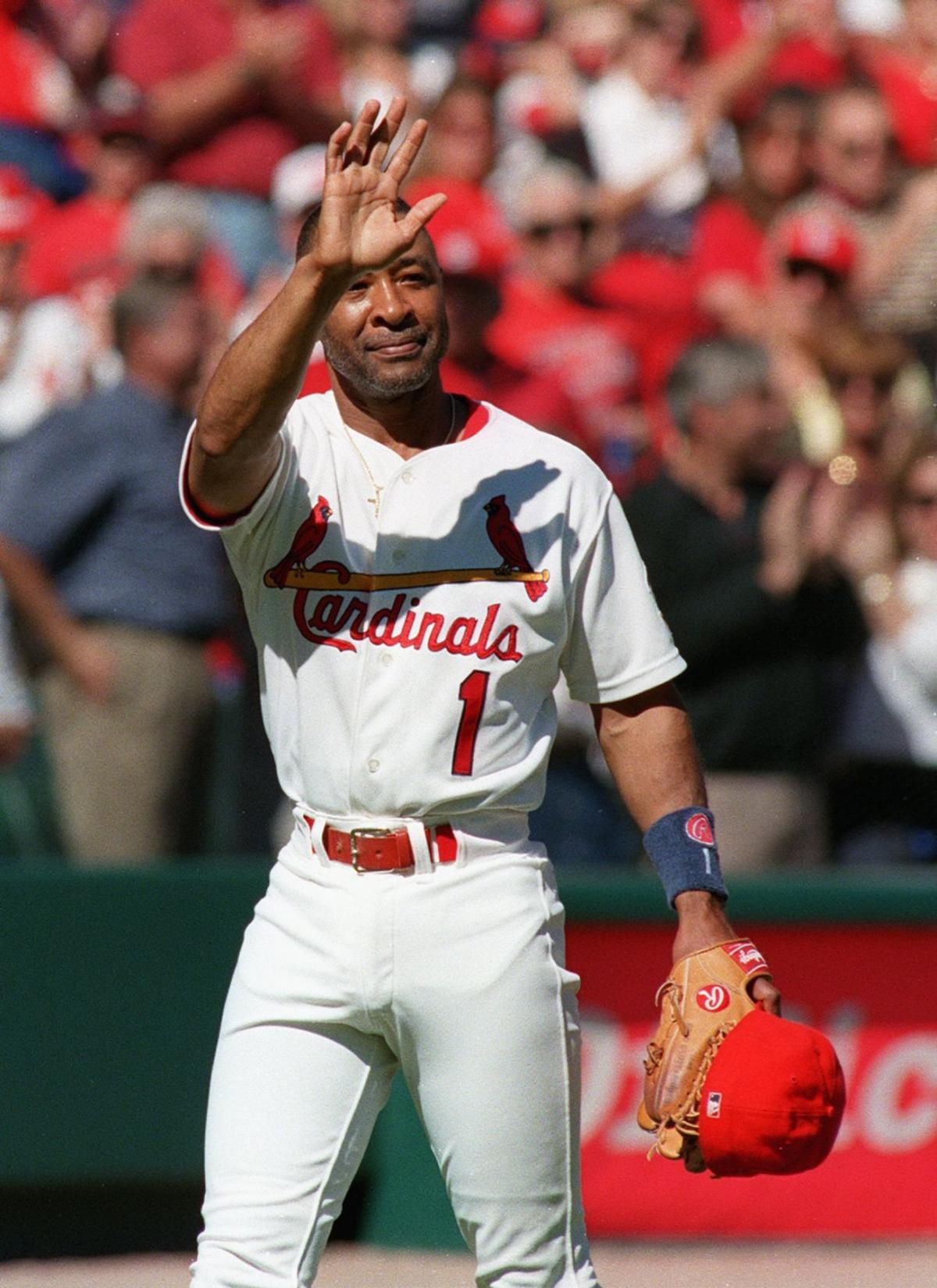 With family members looking on, former St. Louis Cardinals shortstop and  Baseball Hall of Famer Ozzie Smith, tears down his old number one from the  rightfield wall during a game between the