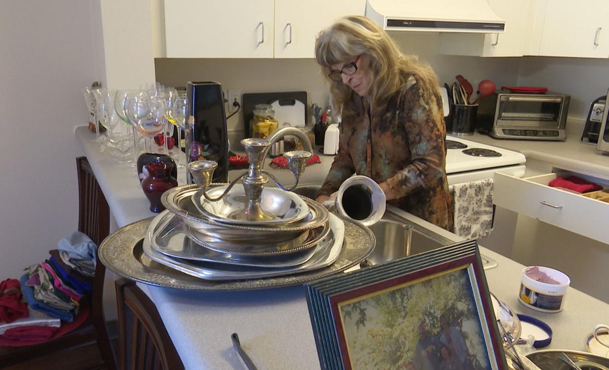 Gayle McCormick works in her kitchen in this still photo taken from video, inside her new apartment in Bellingham
