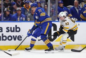 Buffalo Sabres center Tage Thompson looks to make a pass as Boston Bruins center Fraser Minten defends during the second period in game one of the first round of the 2026 Stanley Cup Playoffs at KeyBank Center.