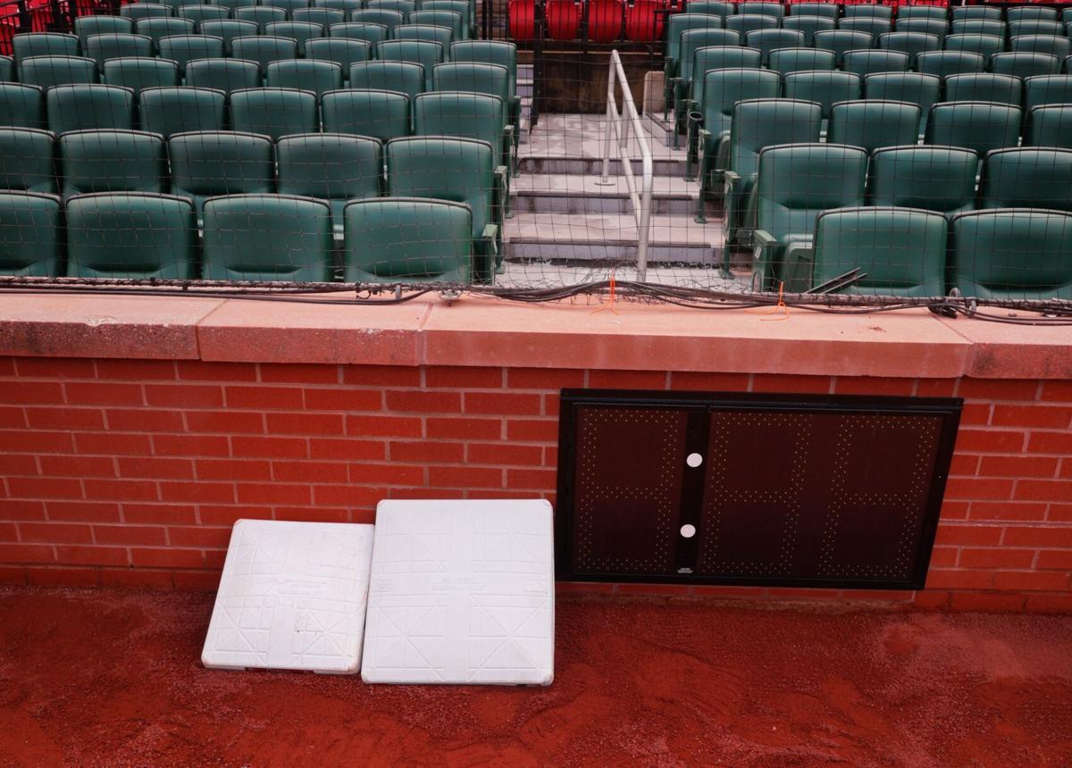 Workers install pitch clocks at Busch Stadium