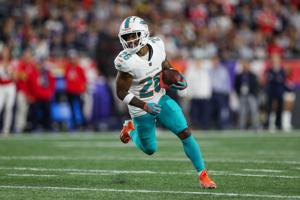 Sep 17, 2023; Foxborough, Massachusetts, USA; Miami Dolphins running back Salvon Ahmed (26) runs the ball during the first half against the New England Patriots at Gillette Stadium. Mandatory Credit: Paul Rutherford-USA TODAY Sports