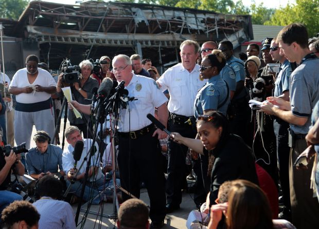 Surrounded by media, Ferguson police ID officer Darren Wilson as shooter of Michael Brown