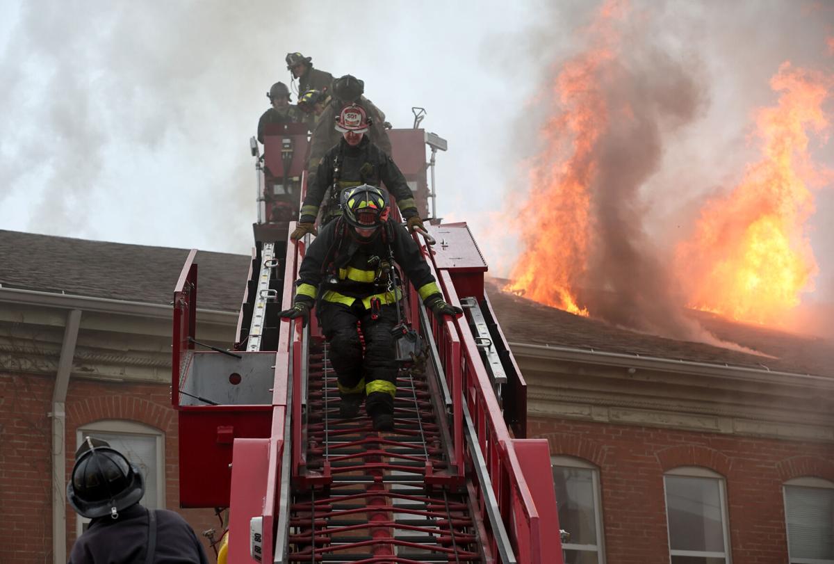 Fire burns through roof of vacant rowhouse apartments in 1000 block of N. Leffingwell Ave