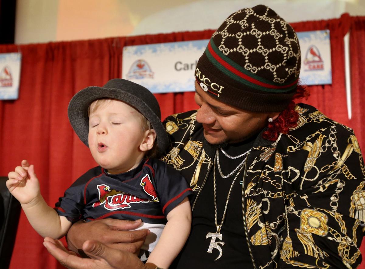 St. Louis Cardinals slugger Albert Pujols stops his autograph session to  sign for son A.J. (5) during the Cardinals Winter Warm-Up in St. Louis on  January 13, 2007. Over 25 thousand badges