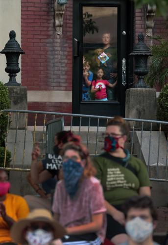 Protesters march to mayor's house