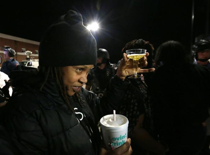 More than 150 demonstrators protest in front of Ferguson Police Station