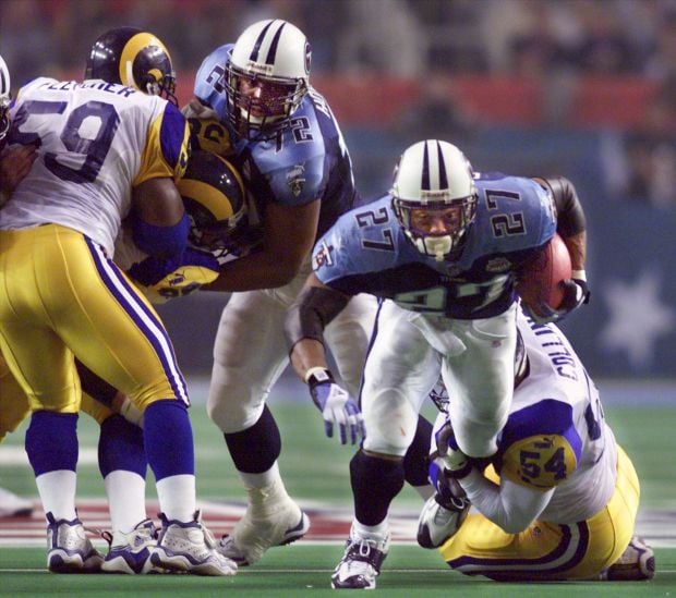 JANUARY 30 2000: Rams quarterback Kurt Warner (13) tries to avoid Titans  defense end Jevon Kearse as the St. Louis Rams defeated the Tennessee  Titans 23-17 to win Super Bowl XXXIV at