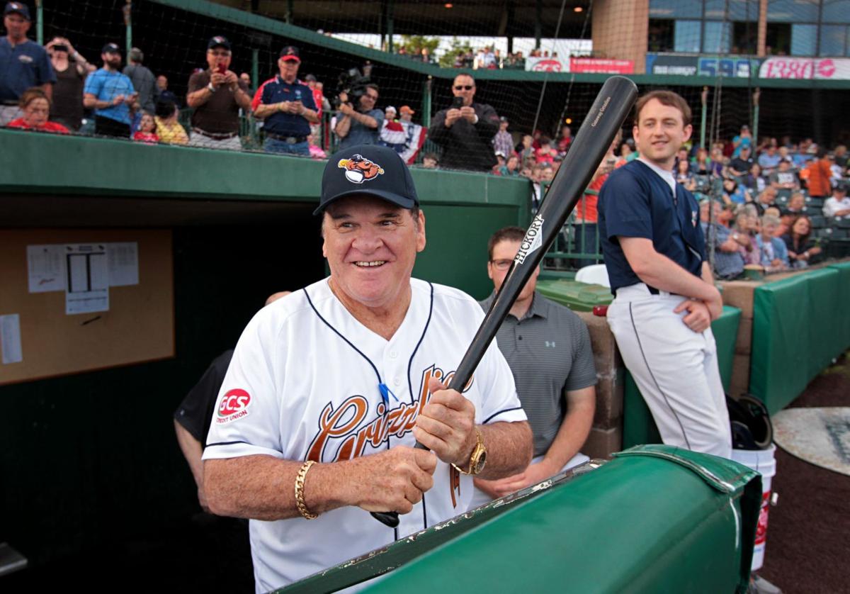 Former Cincinnati Reds manager Pete Rose hits a softball during