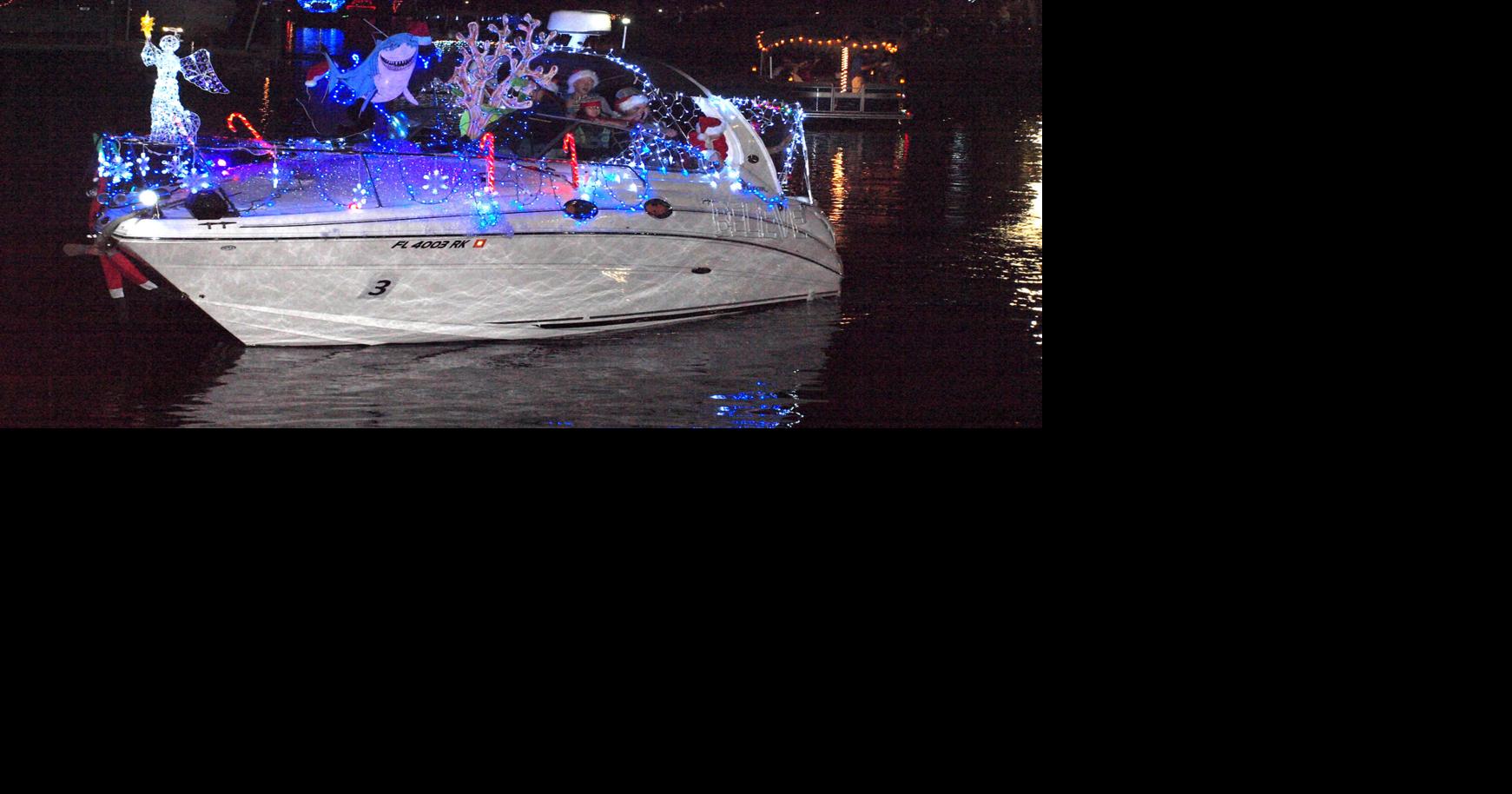 Christmas boat parade lights up night along river News