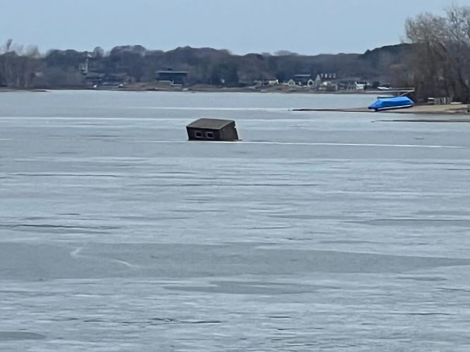 Ice house slowly sinking through thin ice into Prior Lake