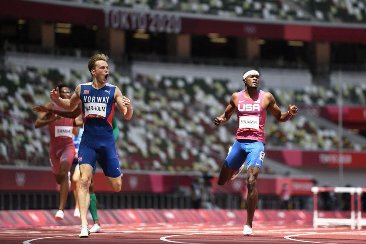 Norway's Karsten Warholm reacts as he wins and breaks the world record ahead of second-placed USA's Rai Benjamin in the men's 400 m hurdles final during the Tokyo 2020 Olympic Games at the Olympic Stadium in Tokyo on August 3, 2021.