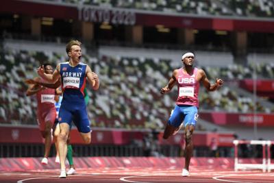 Norway's Karsten Warholm reacts as he wins and breaks the world record ahead of second-placed USA's Rai Benjamin in the men's 400 m hurdles final during the Tokyo 2020 Olympic Games at the Olympic Stadium in Tokyo on August 3, 2021.