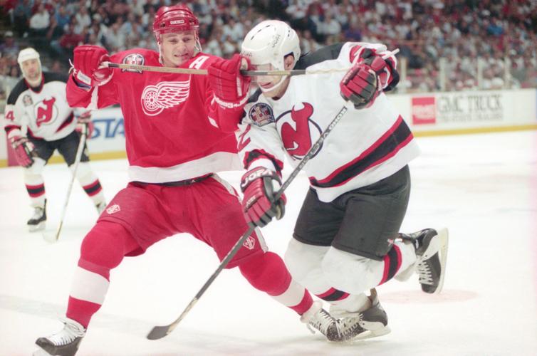 Detroit Red Wings' Rob DiMaio battles New Jersey Devils' Claude Lemieux during Game 4 of the Stanley Cup finals at Brendan Byrne Arena in East Rutherford, N.J., on June 24, 1995.