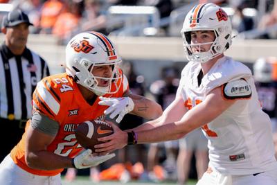 Oklahoma State's Drew Mestemaker hands off to Caleb Hawkins for a touchdown during a spring football game for the Oklahoma State University Cowboys at Boone Pickens Stadium in Stillwater, Okla., Saturday, April 18, 2026.