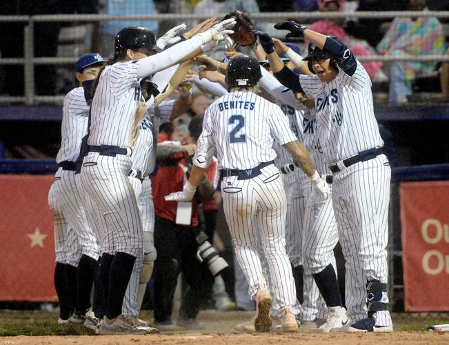 New York Heights catcher Denae Benites is greeted by her team at the dugout after hitting a home run in the inaugural game of the Women's Pro Baseball League at Robin Roberts Stadium Aug. 1, 2026.