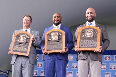 Jeff Kent, Andruw Jones and Carlos Beltran pose for a photo with their Baseball Hall of Fame plaques in Cooperstown, N.Y.